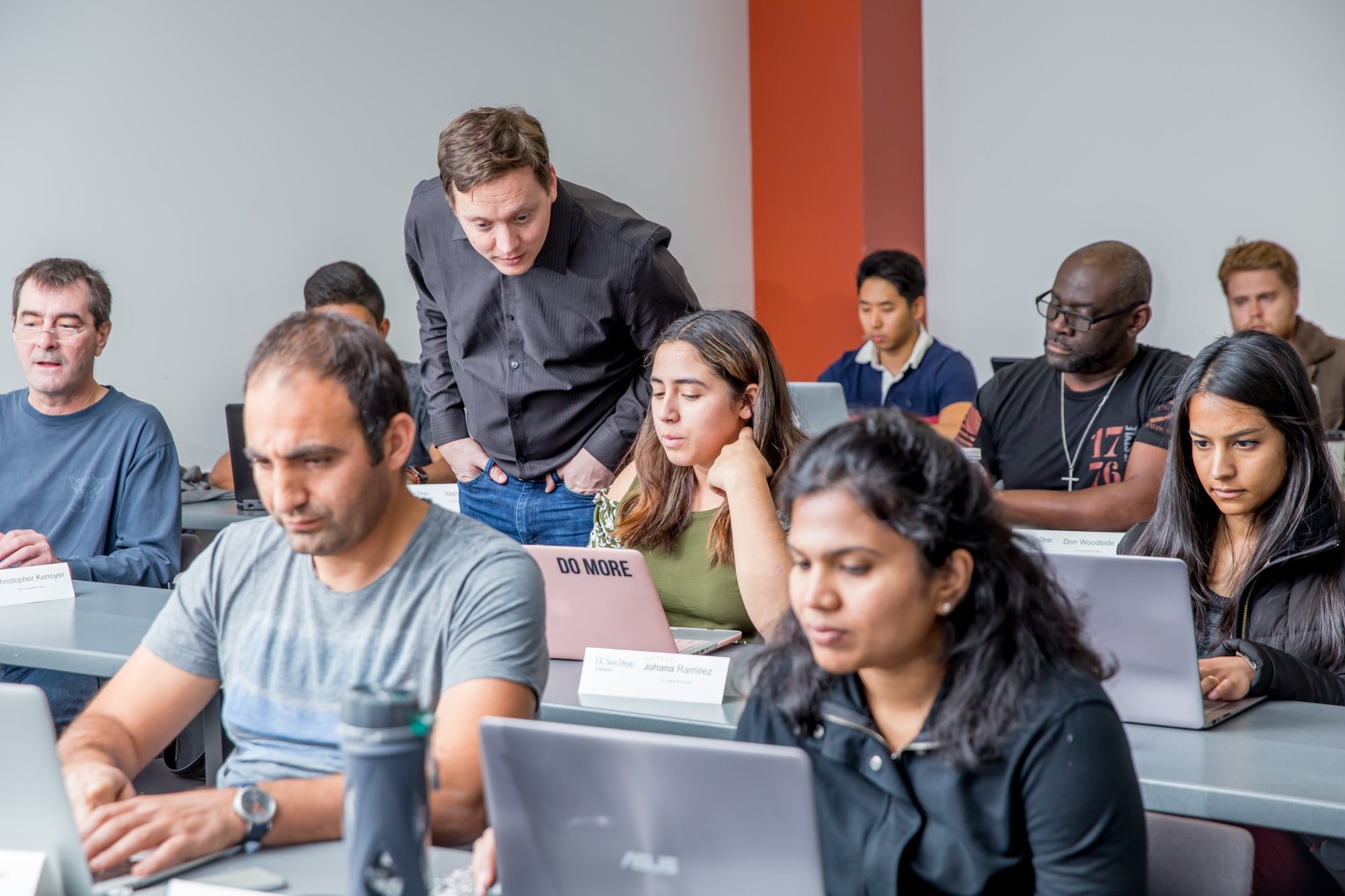 Instructor leaning over to help student