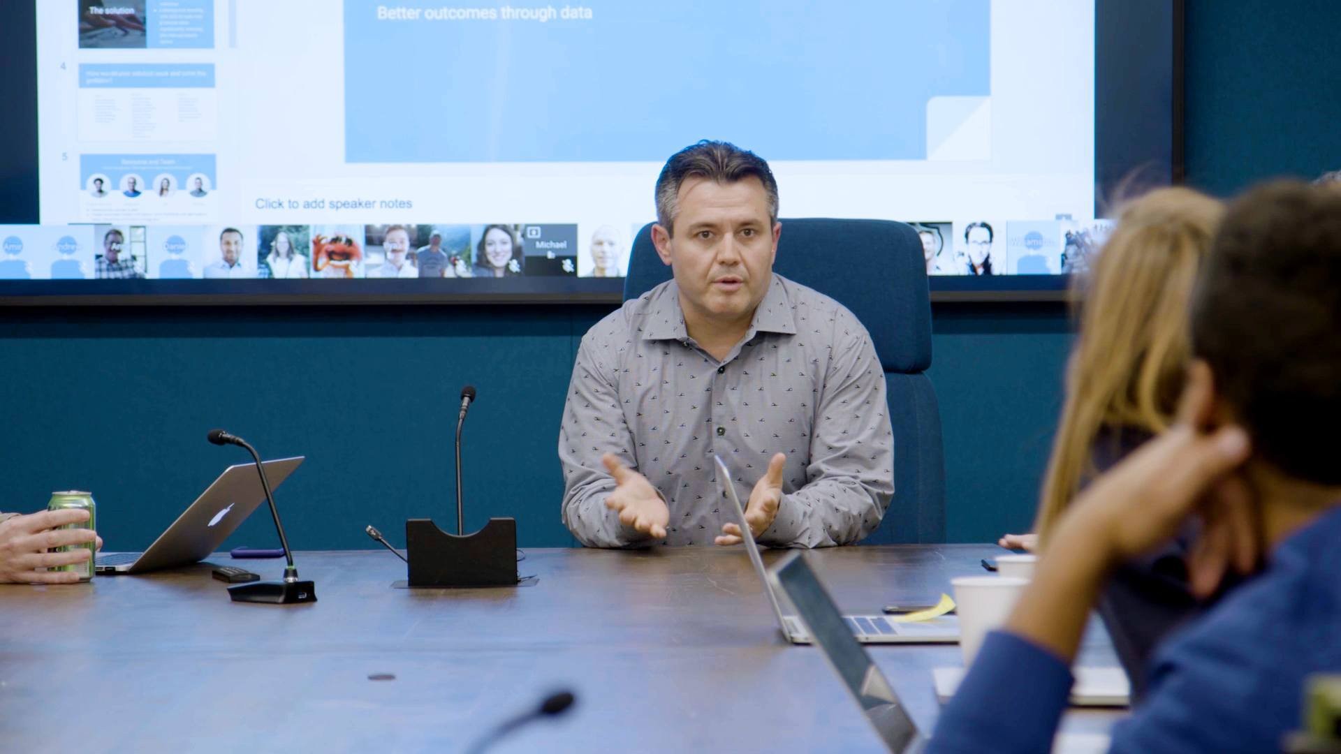 Team lead addresses colleagues at a meeting