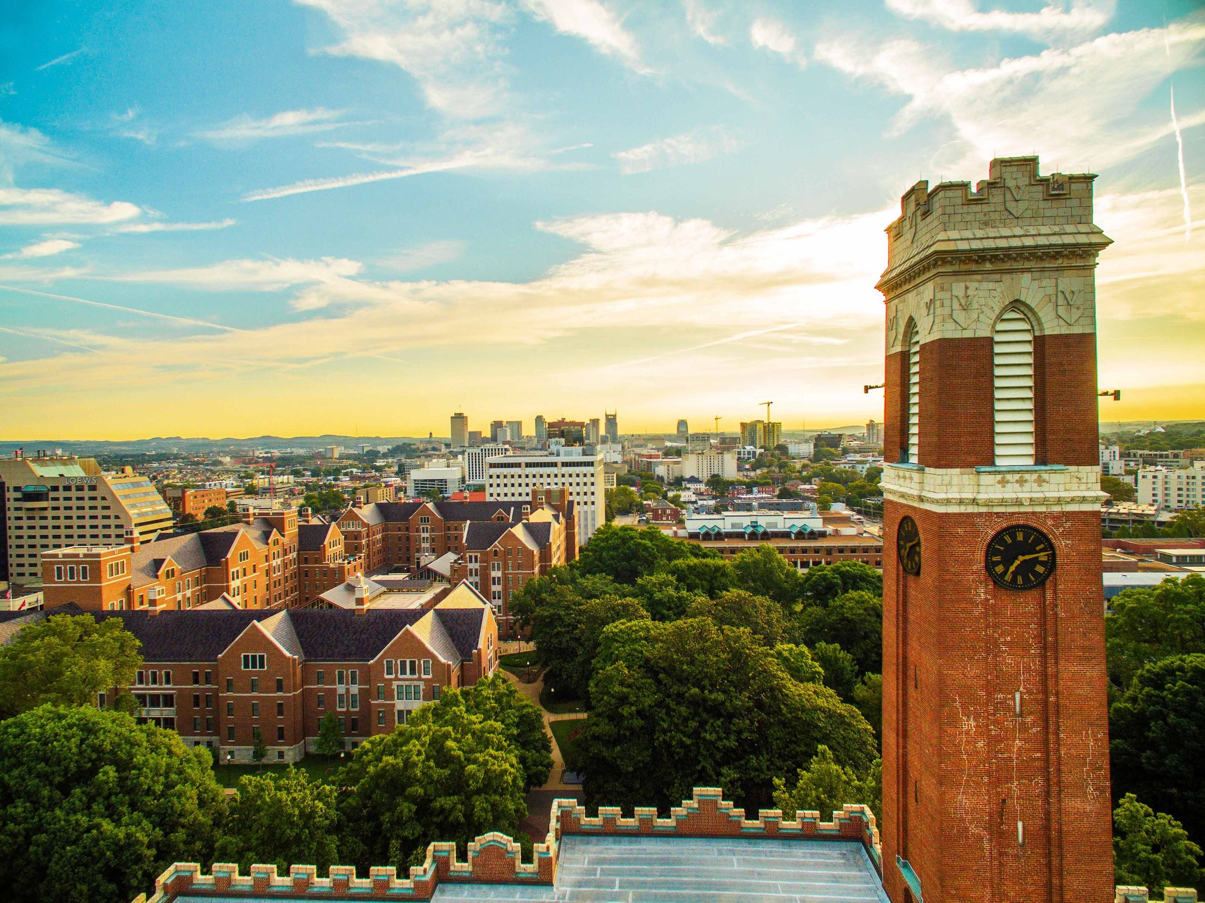 Sunrise in the background of Kirkland Hall's clock tower at Vanderbilt University