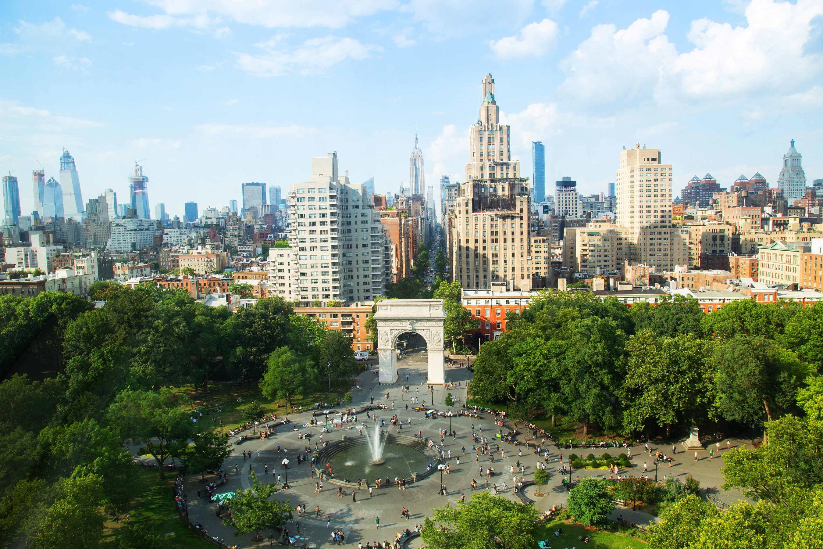 NYU campus buildings next to Washington Square Park on a sunny day