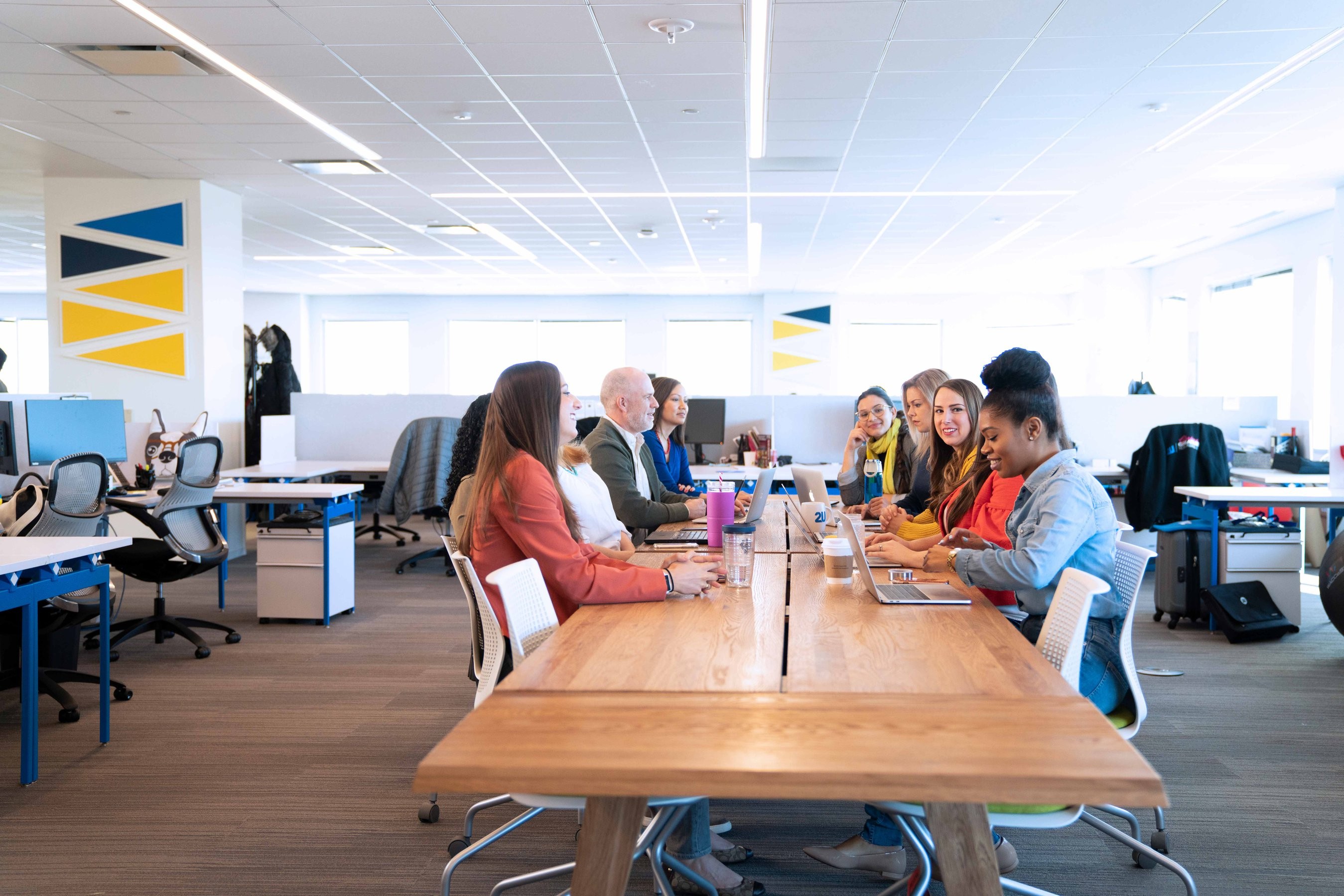 Group of colleagues sitting at a table in their office working on a project